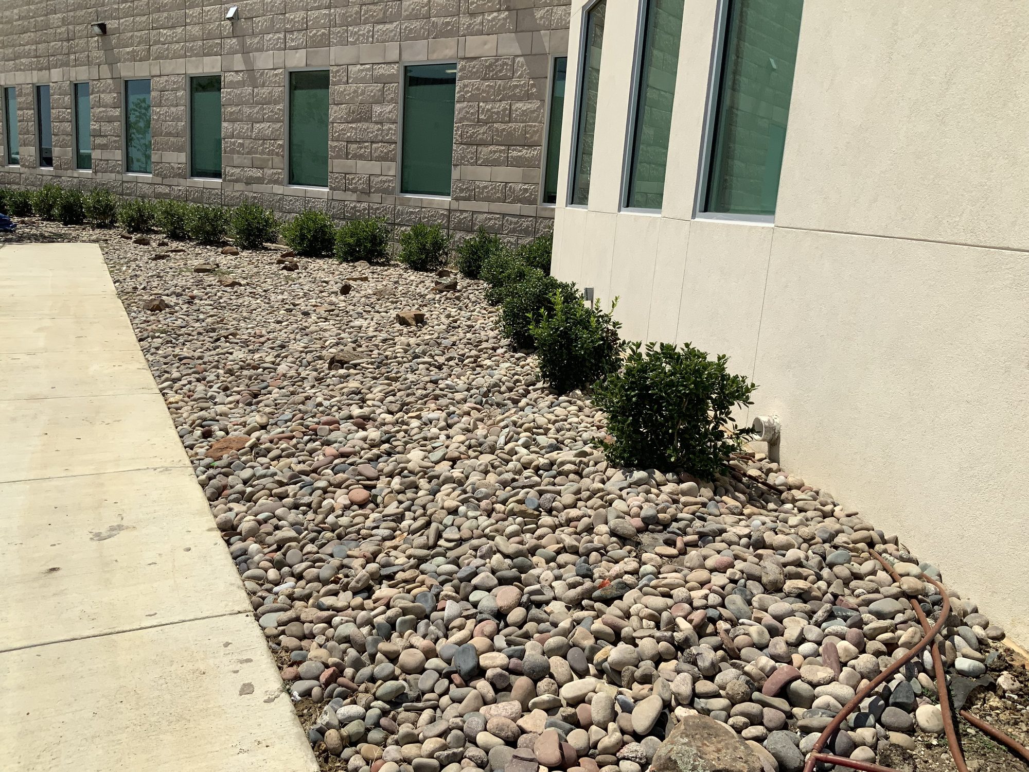 River rock drainage bed after, Imperial Foundation Repair job site in North Texas