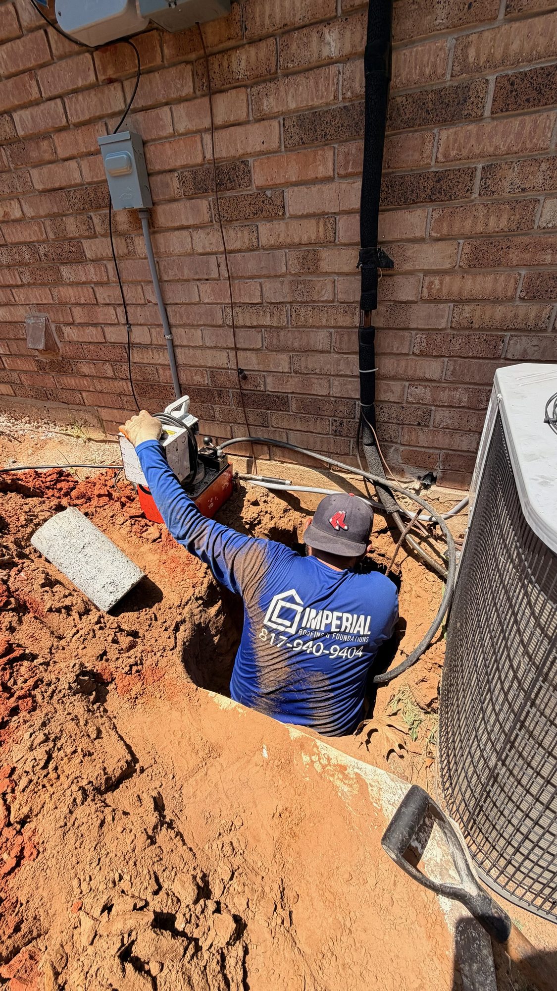Tunnel dig branded crew, Imperial Foundation Repair job site in North Texas
