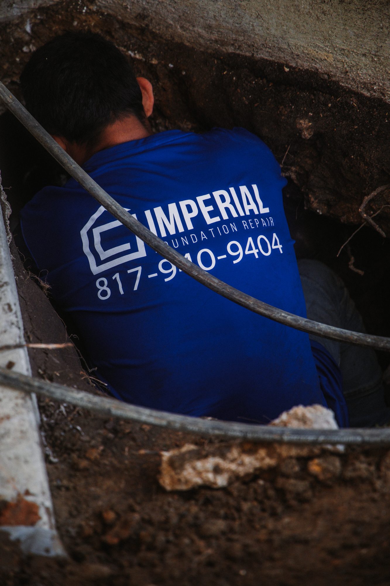 Tunnel worker branded, Imperial Foundation Repair job site in North Texas